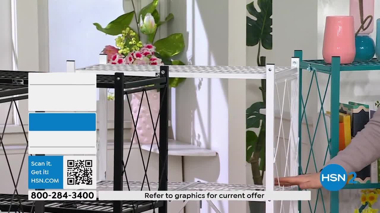A hand reaches out to adjust a white shelving unit. The HSN2 logo is visible on a teal shelf to the right.