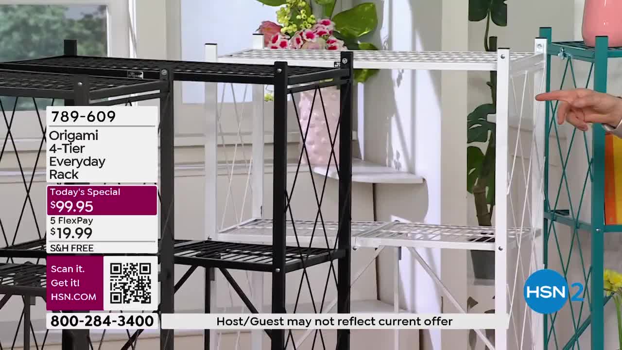 A hand points to a teal shelving unit next to a white one. The black Origami rack in front displays pricing information.