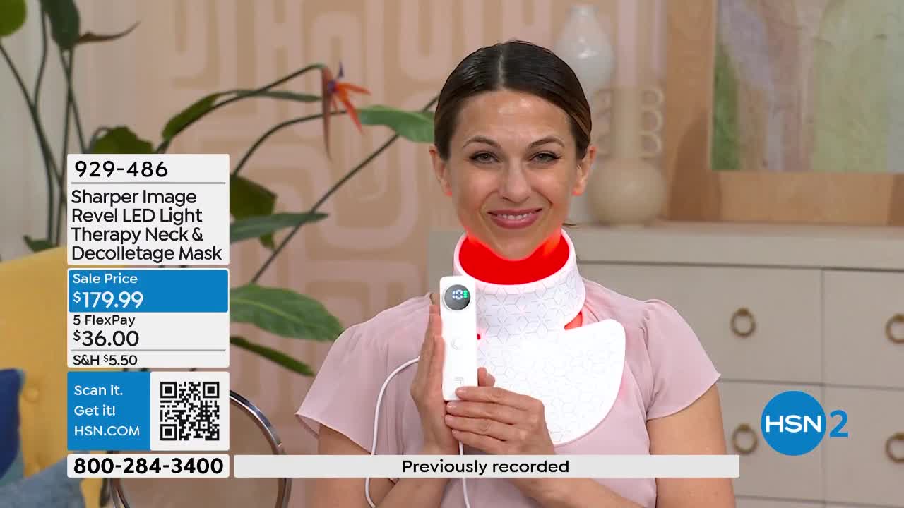 A woman smiles, holding a white device that wraps around her neck. A red light glows from the device's collar.