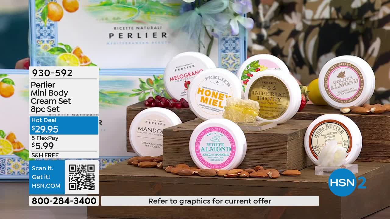 A collection of Perlier mini body creams sits on wooden crates, surrounded by almonds and a honeycomb. The HSN2 logo appears in the lower right corner.
