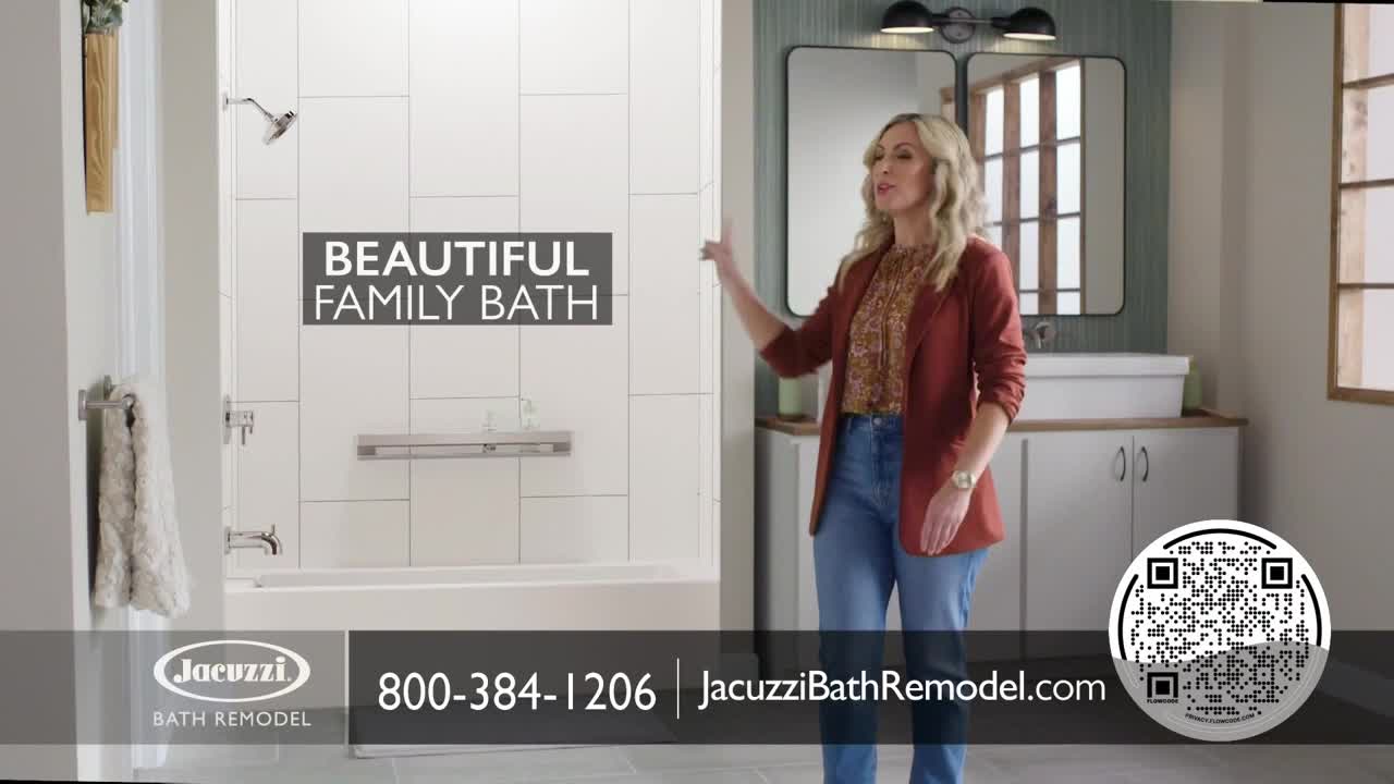 A woman in a blazer gestures toward a modern bathroom, highlighting the shower and vanity. The Jacuzzi Bath Remodel logo and a phone number are displayed at the bottom of the screen.
