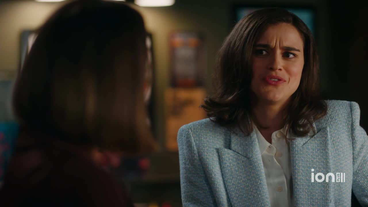 A woman in a light blue blazer is talking, her expression a mix of confusion and mild annoyance. The ION Plus logo is visible in the corner.
