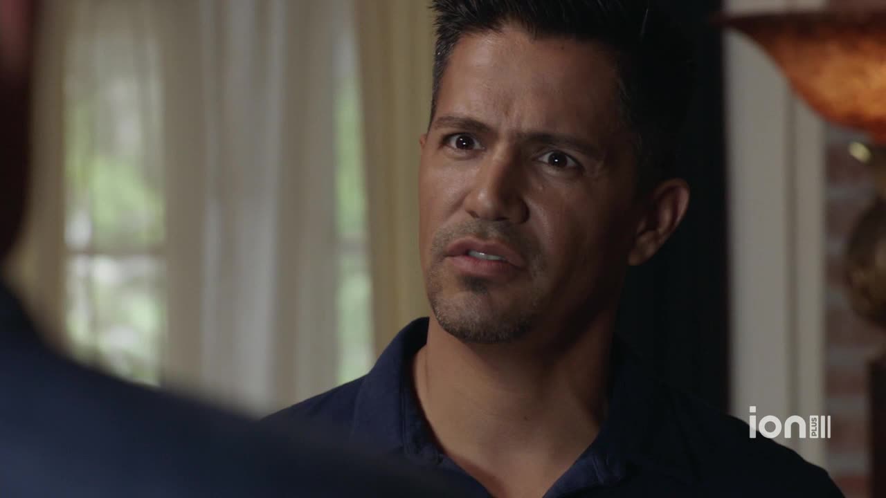 The man's eyes widen as he listens, his mouth slightly open. He's wearing a dark blue shirt, and the ION Plus logo is visible in the corner.
