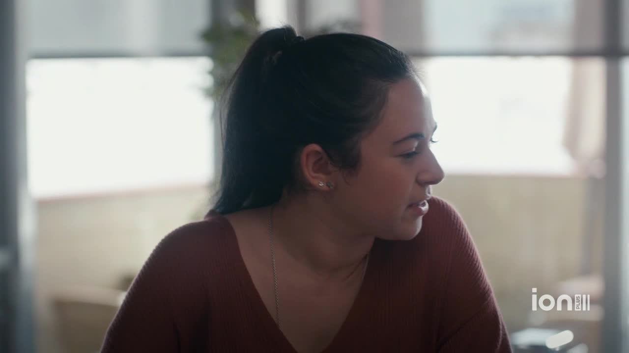 A young woman, wearing a rust-colored sweater, is looking off to the side. The ION Plus logo is visible in the corner.
