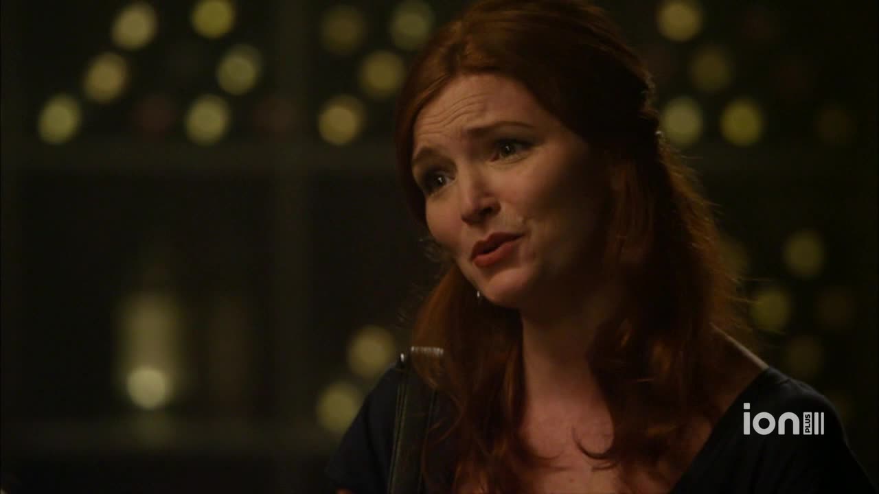 A woman with red hair is speaking, her expression earnest. The ION Plus logo is visible in the corner, suggesting this is a scene from a show.
