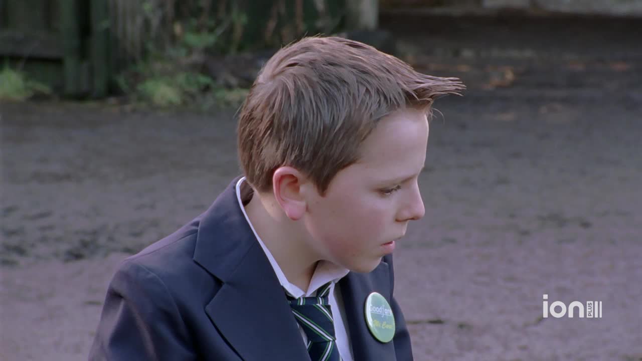 A boy in a school uniform looks down, his hair spiked up in front. The ION Plus logo is visible in the corner.
