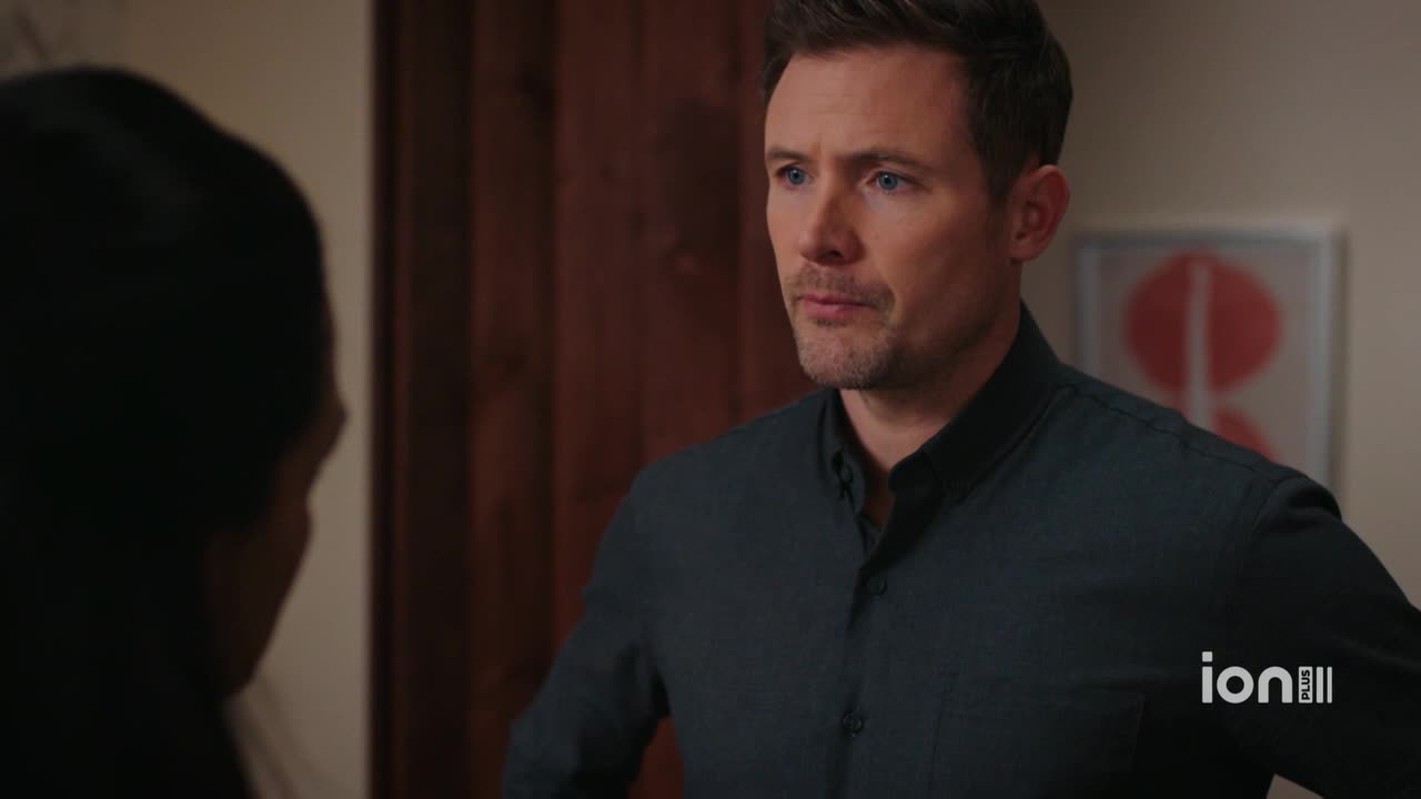 A man in a dark shirt looks at someone off-screen, his expression serious. The ION Plus logo is visible in the corner.
