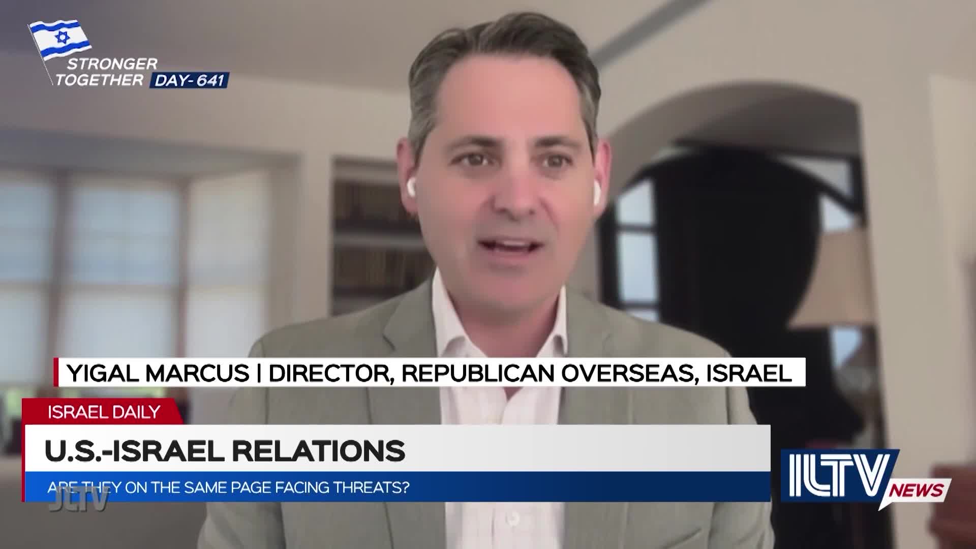 A man in a light jacket is speaking, presumably on Jewish Life Television, with the topic of U.S.-Israel relations. The lower third identifies him as Yigal Marcus, Director of Republican Overseas, Israel.
