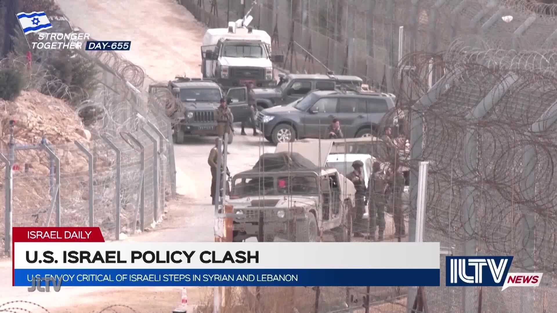 A convoy of vehicles, including a Humvee, is parked on a dirt road, with soldiers milling around. Barbed wire fences and a wall line the road, and the scene is being reported on Jewish Life Television.
