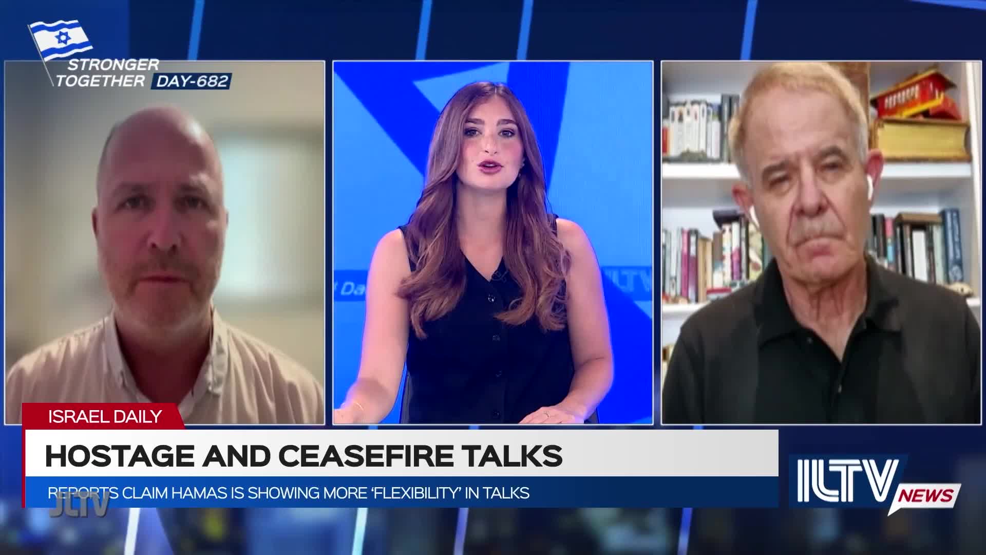A news anchor on Jewish Life Television, flanked by two guests, is discussing hostage and ceasefire talks. The screen displays "Israel Daily," and the lower third reads "Hostage and Ceasefire Talks."
