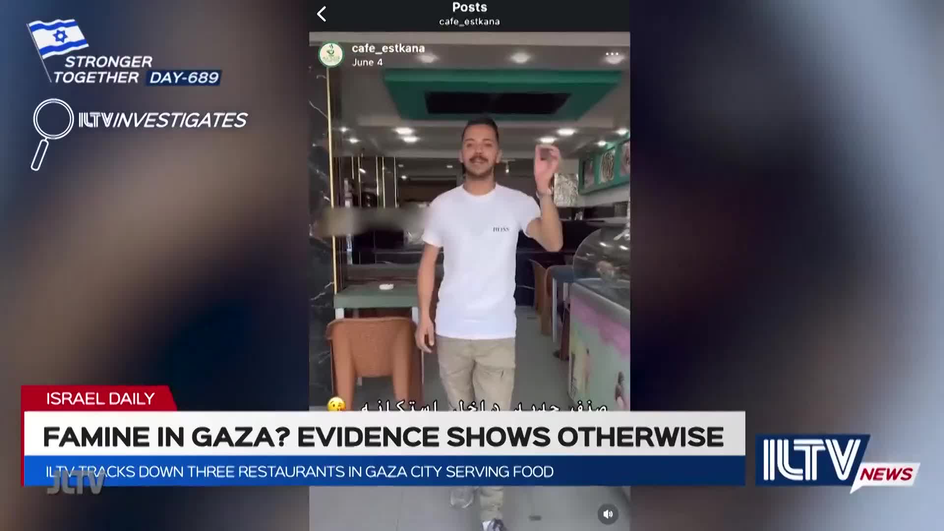 A man in a white t-shirt gestures with his hand inside a cafe, the scene captured on a screen. The ILTV logo and a headline about famine in Gaza appear at the bottom of the screen.
