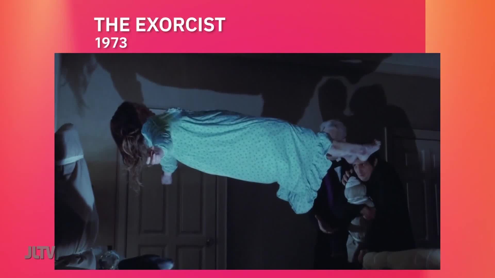 A girl in a nightgown floats horizontally in the air, her face contorted. Two men struggle to hold her down, as shadows loom in the background on this clip from United States Jewish Life Television.
