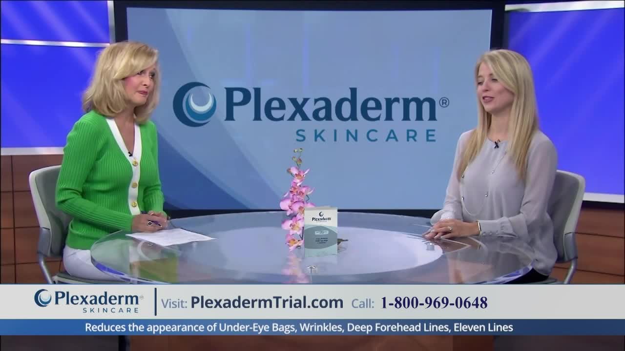 Two women sit at a curved desk, facing each other. A product box and a small flower arrangement sit between them, beneath the Plexaderm logo.
