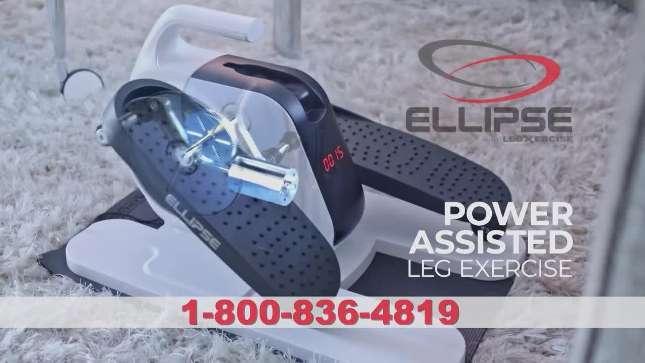 An Ellipse exercise machine sits on a plush, white carpet. The digital display on the machine shows "00:15," and the words "Power Assisted Leg Exercise" are visible.
