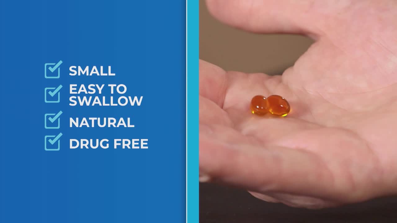 Two small, amber-colored capsules rest in the palm of a hand. Beside them, a list highlights the product's attributes: small, easy to swallow, natural, and drug-free.
