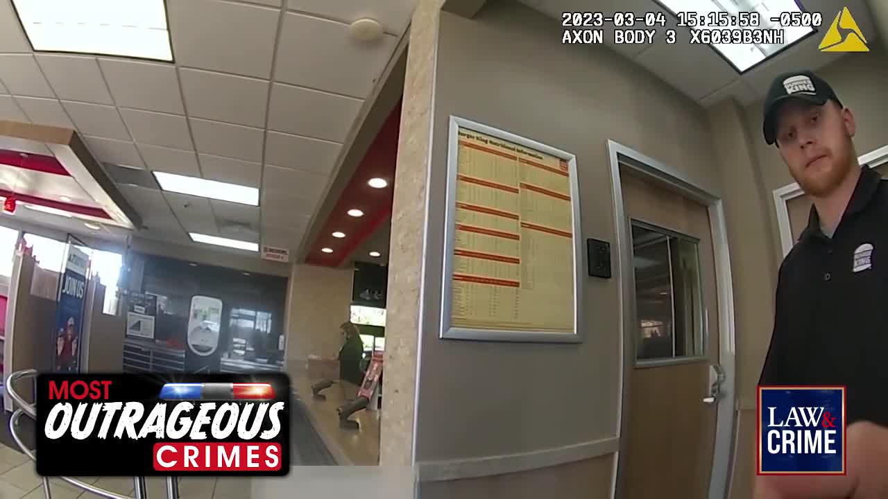 A young man in a Burger King uniform stands by a door, his expression unreadable. Behind him, the restaurant's interior is visible, with a woman in a green jacket standing near the counter.