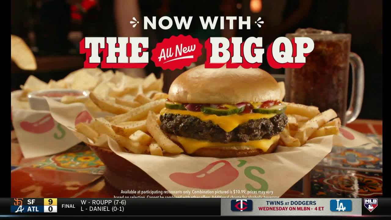 A juicy burger with melted cheese and a side of fries sits in a basket, advertised during an MLB Network broadcast. A frosty mug of soda completes the tempting Chili's meal.
