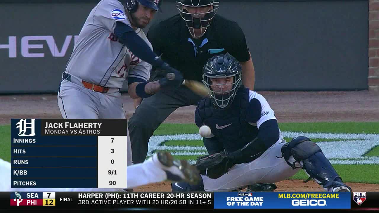 The batter swings, and the catcher is down, glove open, ready for the pitch. The ball is just about to smack into the catcher's mitt, right in front of the umpire.

