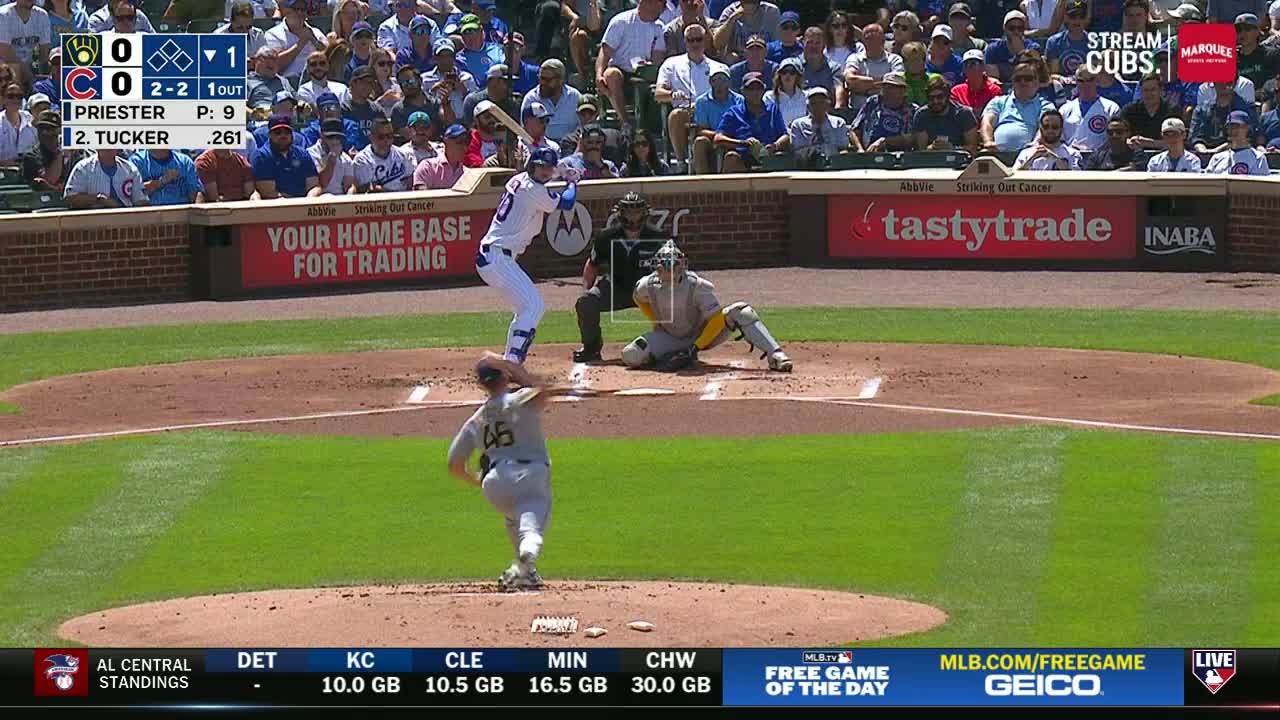 The pitcher, number 45, is mid-windup, arm extended, ready to hurl the ball. The batter, in a blue and white uniform, is set, bat held high, eyes locked on the incoming pitch.
