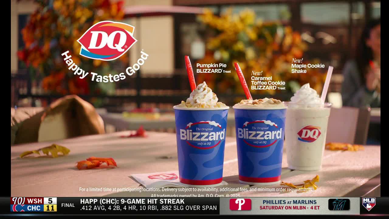 On the MLB Network broadcast, a Dairy Queen ad shows three seasonal treats: two Blizzards topped with whipped cream and a shake, all sitting on a table. The ad's backdrop is a blurred outdoor scene with fall foliage.
