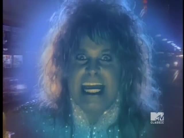 Ozzy Osbourne's face fills the screen, his eyes wide and mouth open in a manic grin. A blue light surrounds him, and the MTV Classic logo is visible in the corner.
