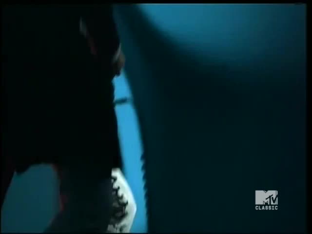 A dark figure, lit only by a strong spotlight, moves to the right. The MTV Classic logo is visible in the corner.

