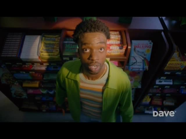 A young man, dressed in a green jacket, stares wide-eyed from behind a convenience store counter. Shelves of snacks and magazines fill the background, and the "Dave" logo is visible at the bottom.
