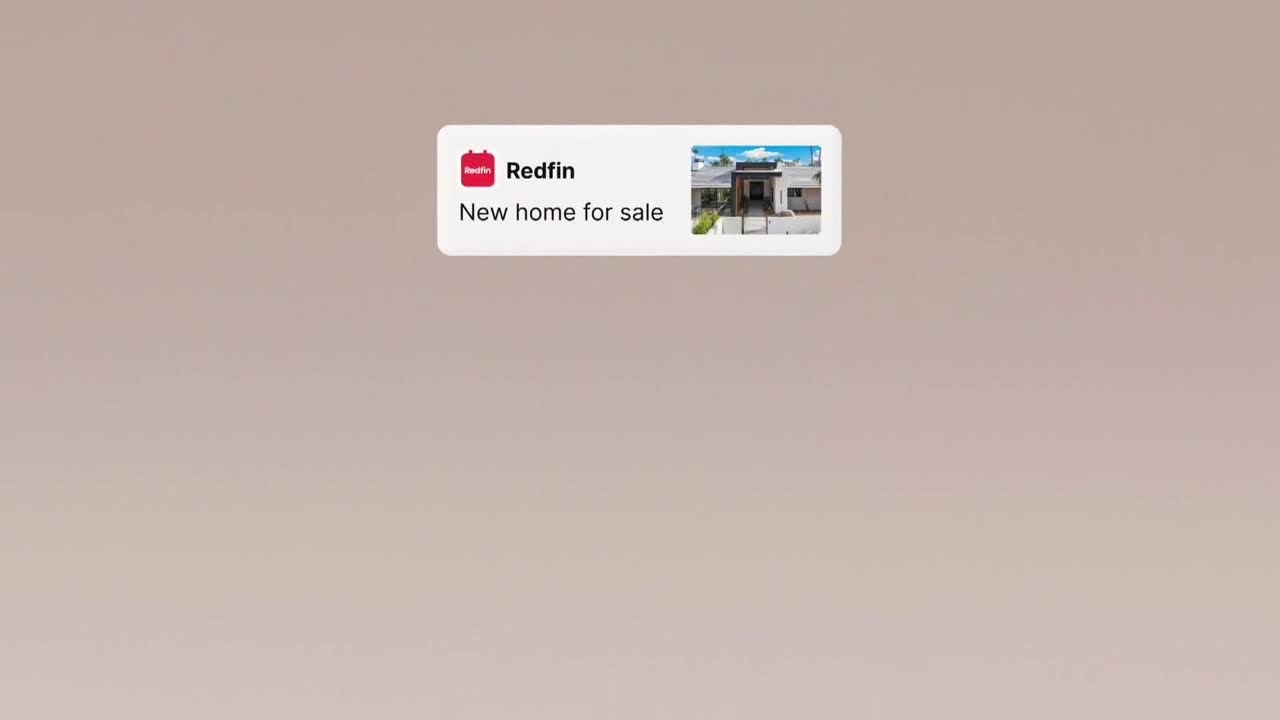 A Redfin notification hovers at the top, advertising a new home for sale. The image shows a modern house with a manicured lawn.

