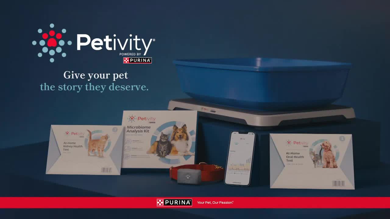 A blue litter box sits on a scale, with various pet health test kits and a smartphone arranged in front. The Petivity logo, powered by Purina, is displayed above the products.
