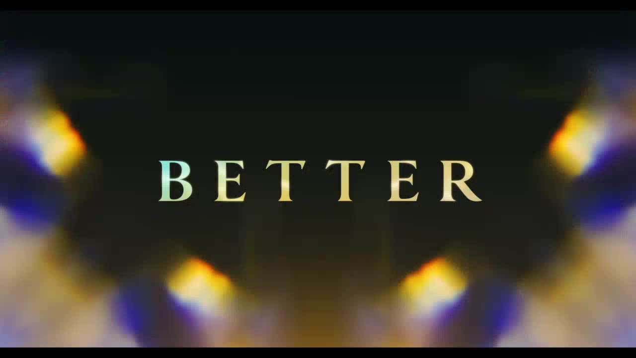 "BETTER" is spelled out in elegant, gold lettering, centered against a dark background.  Faint, shimmering light refracts from the edges, adding a subtle, colorful glow.
