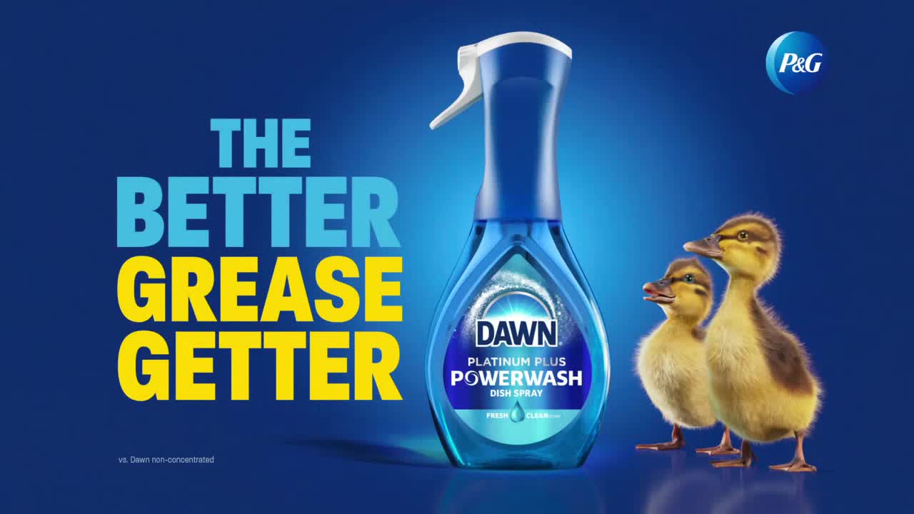 A bottle of Dawn Powerwash dish spray sits front and center, flanked by two fluffy ducklings. Bold text proclaims the product's grease-fighting abilities against a deep blue backdrop.
