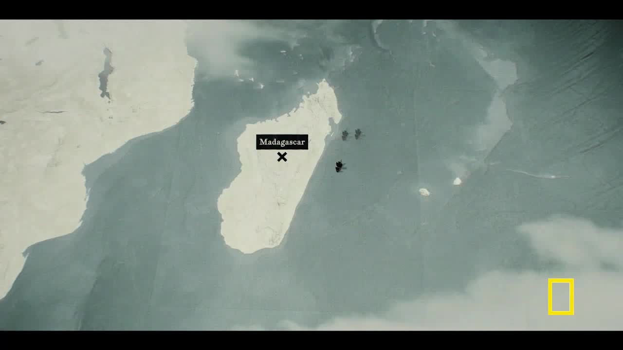 A map of Madagascar and the surrounding ocean is displayed, with small figures possibly representing boats or people. The National Geographic logo sits in the lower right corner, hinting at a documentary or exploration.
