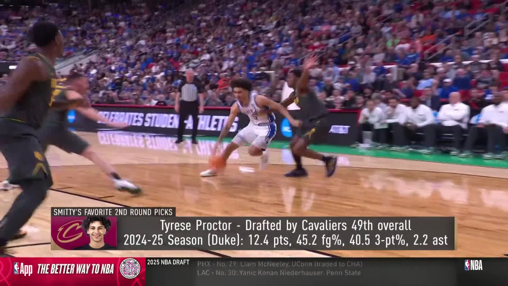A player in a blue jersey dribbles the ball, driving toward the basket as a defender in a dark uniform tries to keep up. The action unfolds on an NBA court, broadcast on NBA TV.
