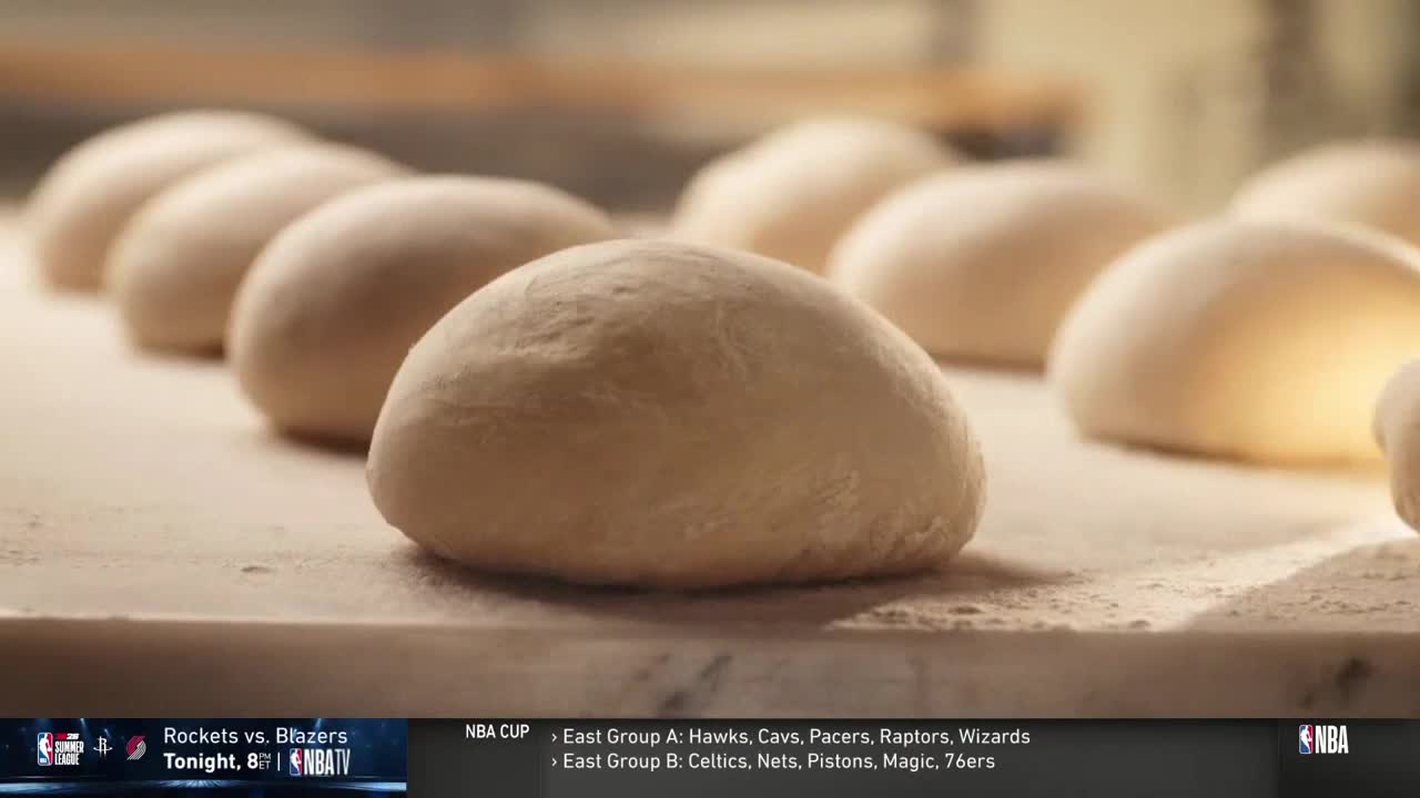 A row of dough balls, pale and smooth, sit on a floured surface. The NBA TV graphic in the corner reminds me that the game is coming up.
