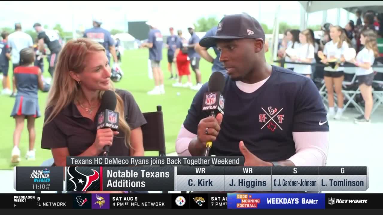 A woman and a man are seated, each holding a microphone with the NFL Network logo. The man, wearing a navy t-shirt and a baseball cap, is speaking.
