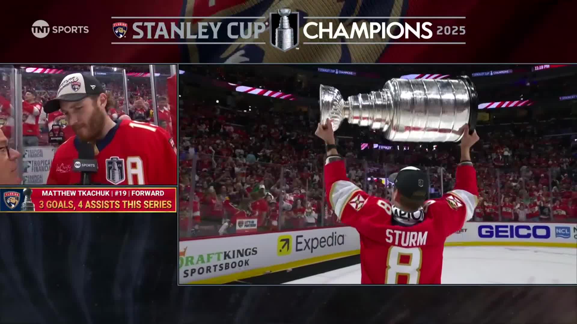 A player in a red jersey hoists the Stanley Cup over his head. The crowd in the arena cheers as the NHL Network cameras capture the moment.
