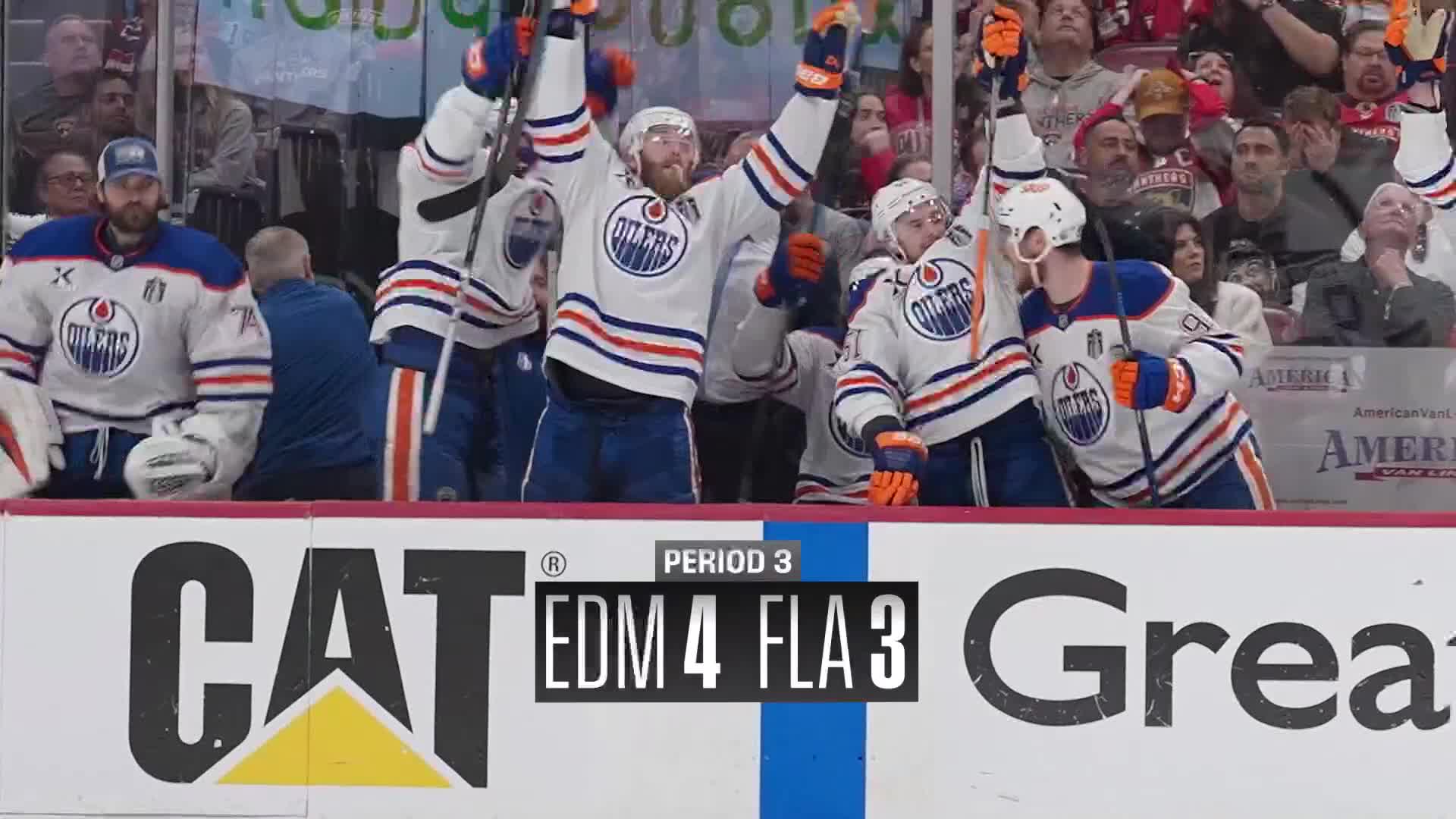 Edmonton Oilers players, in their white and blue jerseys, are celebrating on the bench with arms raised. The scoreboard shows the Oilers leading the Florida Panthers 4-3 in the third period.
