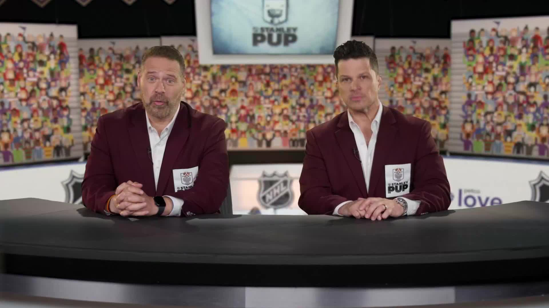 Two men in matching burgundy blazers sit behind a dark desk, facing the camera. The background is a cartoon crowd and a Stanley Pup logo, likely for a broadcast on NHL Network.
