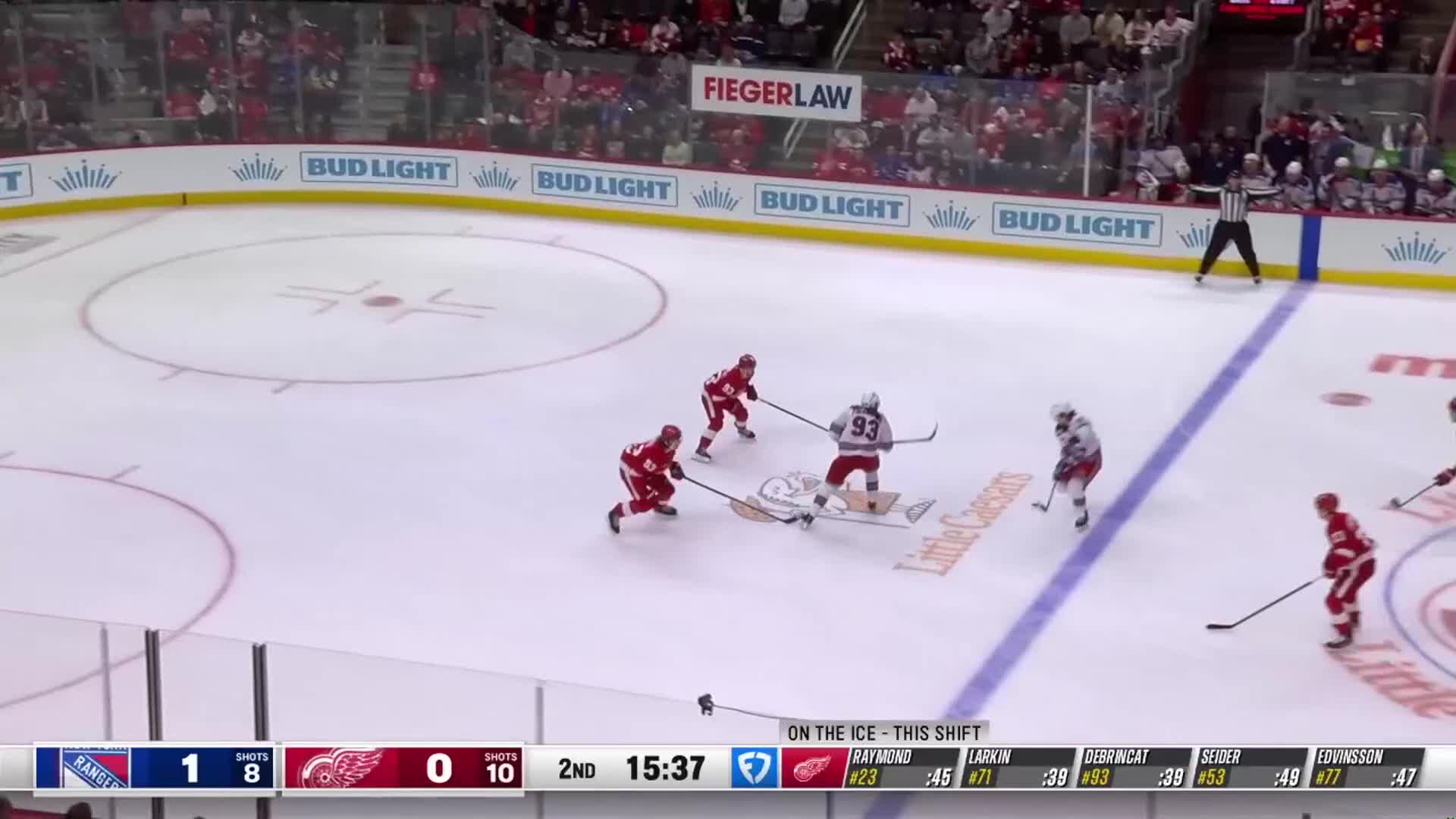 The Detroit Red Wings, in red, are skating toward the Rangers' zone.  Number 93 is trying to maintain possession of the puck, with several Red Wings players moving up ice.
