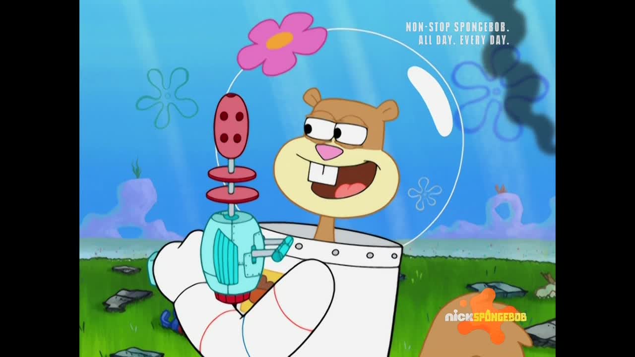 Sandy Cheeks, in her space helmet, grins with a mischievous look, holding a futuristic-looking ray gun. A pink flower floats above her head in this Nicktoons scene from the United States.
