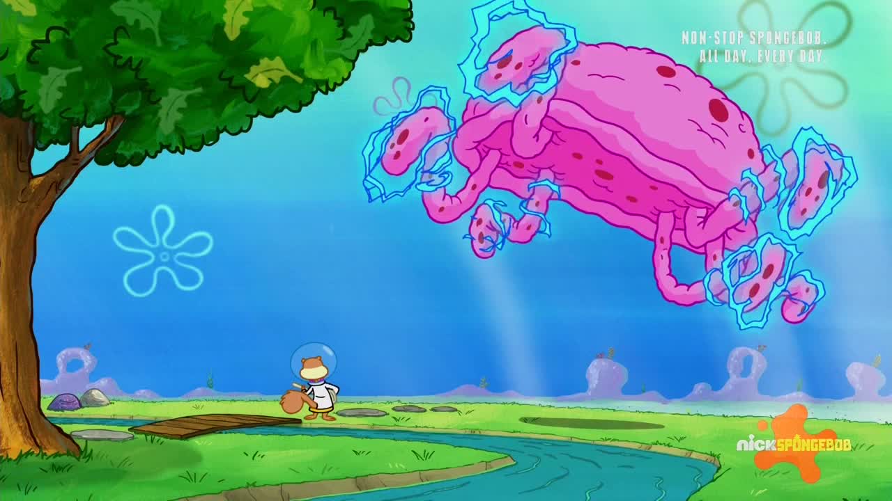 A giant, pink creature with glowing blue appendages hovers in the sky. Sandy, a cartoon character, stands on the ground, looking up at the strange sight.
