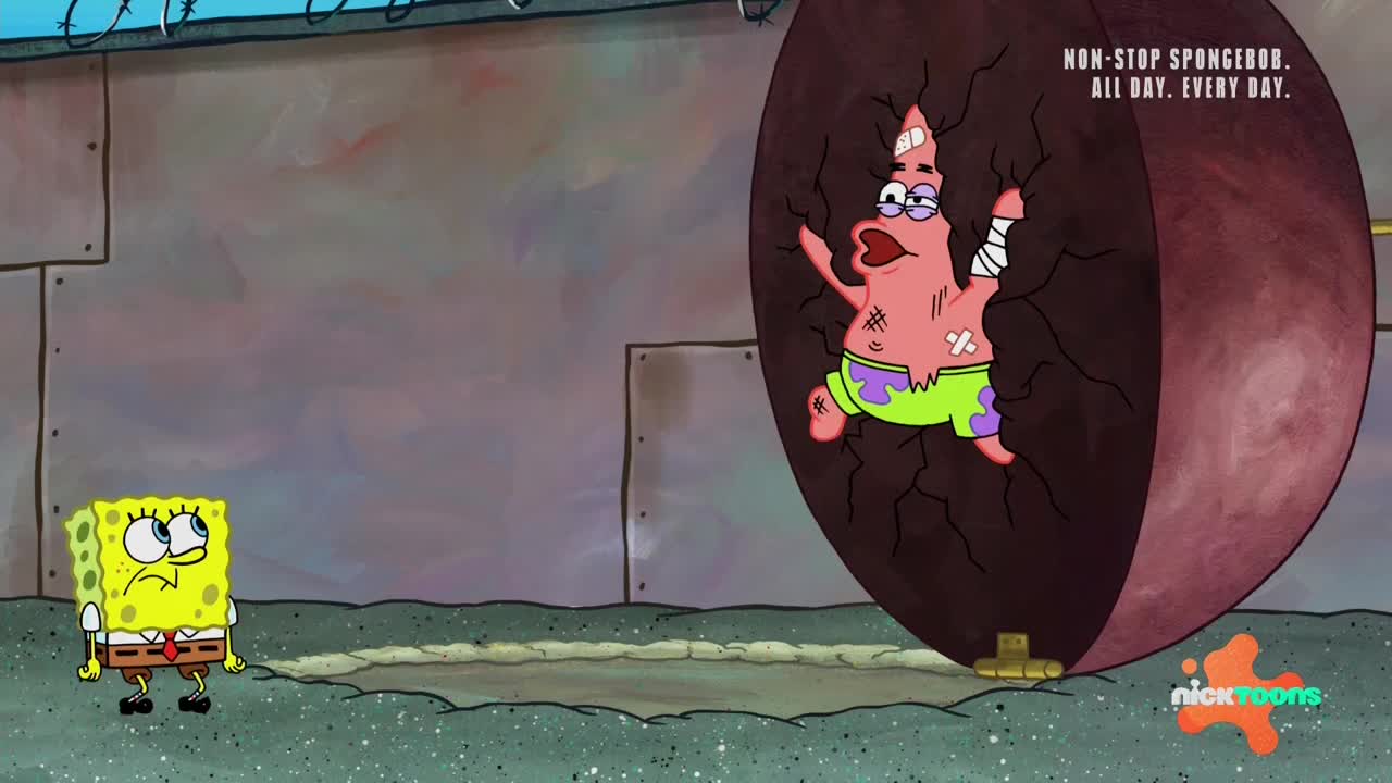 Patrick Star is stuck inside a giant, cracked sphere, looking dazed with bandages on his head and arm. Spongebob Squarepants stands nearby, looking concerned.
