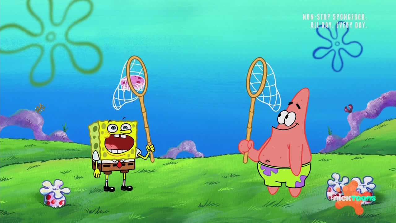 SpongeBob and Patrick stand on the green grass, nets raised, with a jellyfish caught in one of the nets. SpongeBob has his mouth wide open, and Patrick looks on with a smile.
