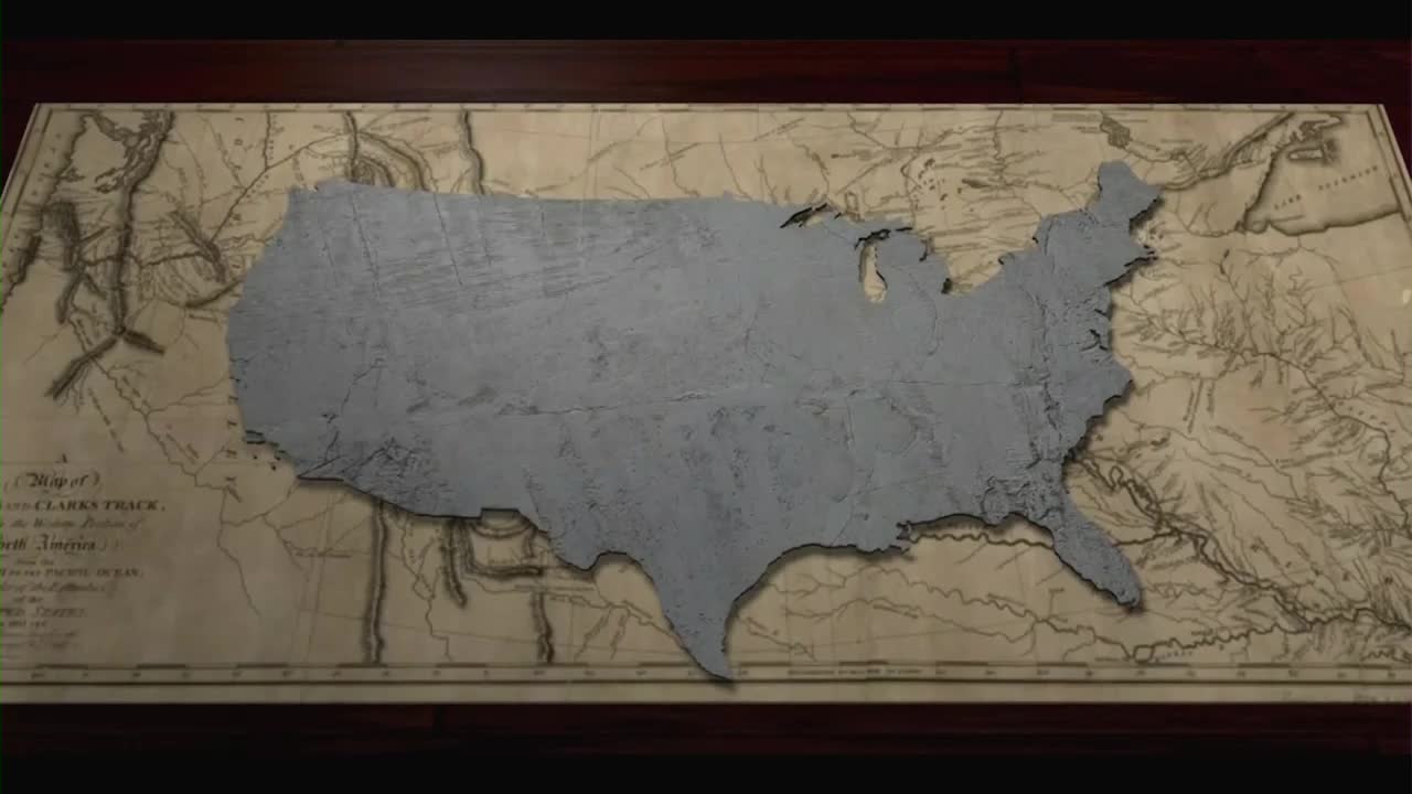 A gray, textured outline of the United States sits atop an antique map. The map, likely used on One America News Network, is a backdrop for a segment.
