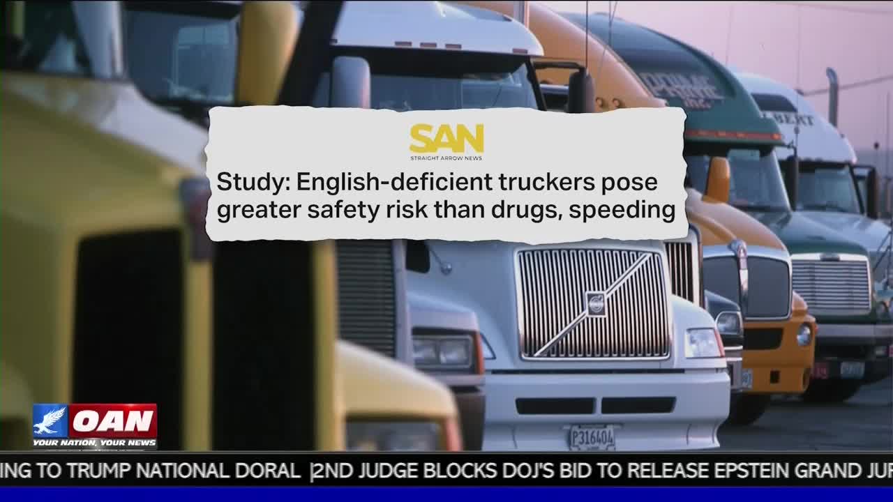 A row of parked semi-trucks fills the frame, their cabs lined up in a row. The One America News Network logo sits at the bottom, with a headline about truckers overlaid on the image.
