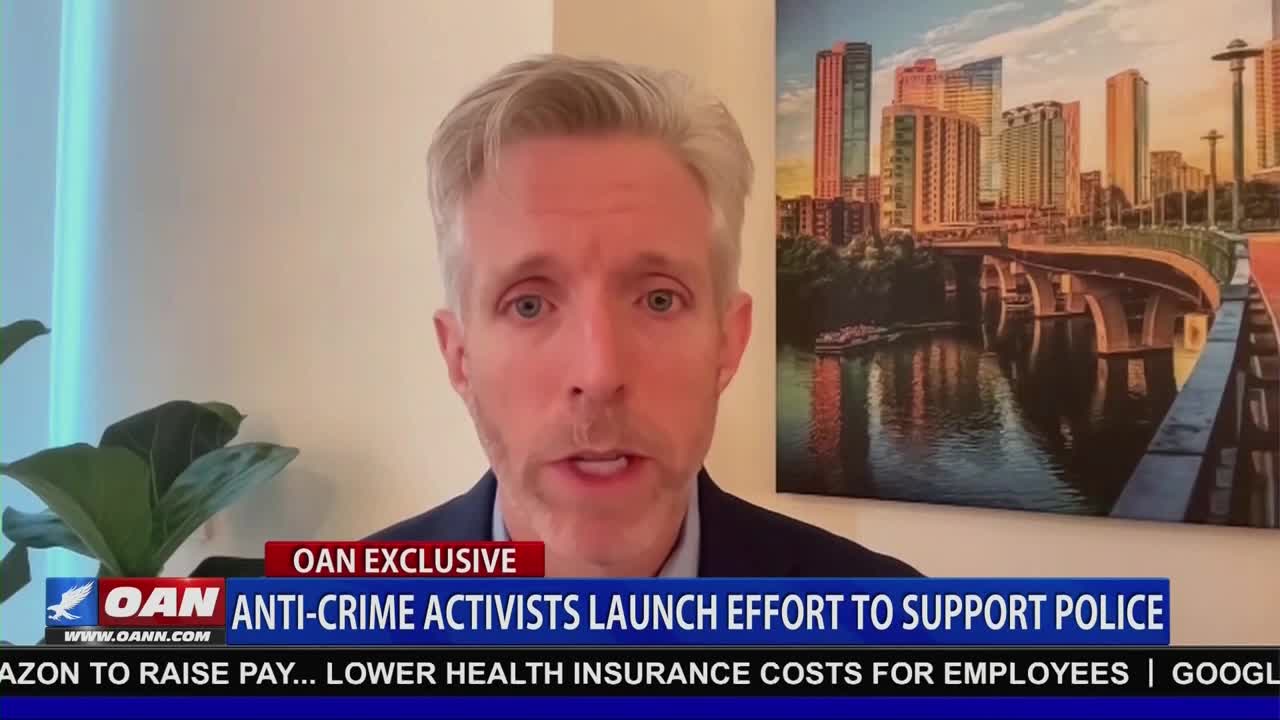 A man with graying hair and a dark suit jacket speaks directly to the camera, his mouth moving as he talks. The lower third of the screen, branded with the OANN logo, displays the headline "ANTI-CRIME ACTIVISTS LAUNCH EFFORT TO SUPPORT POLICE."
