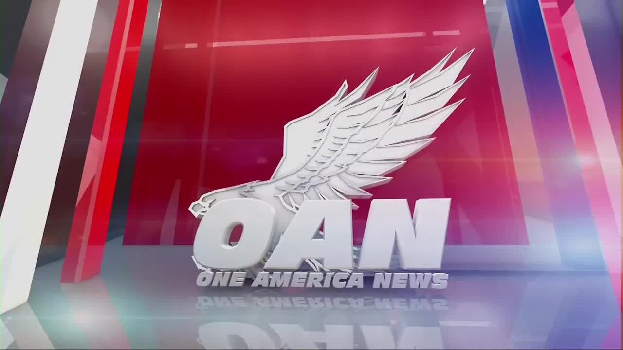 The logo for One America News, with its eagle emblem, is front and center. The letters "OAN" are in bold white, and the words "ONE AMERICA NEWS" are stacked below.
