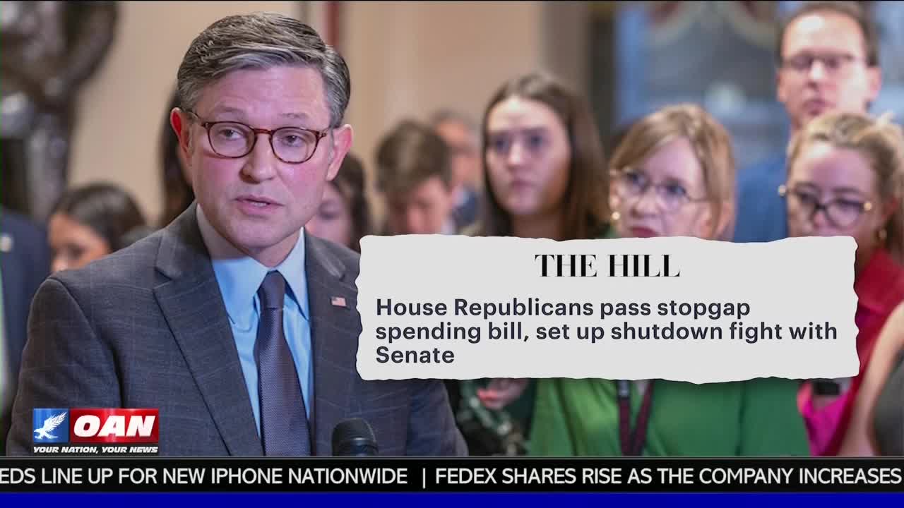 A man in a suit, wearing glasses, speaks into a microphone, likely addressing the press. The One America News Network logo is visible at the bottom, and a headline states that House Republicans passed a spending bill.
