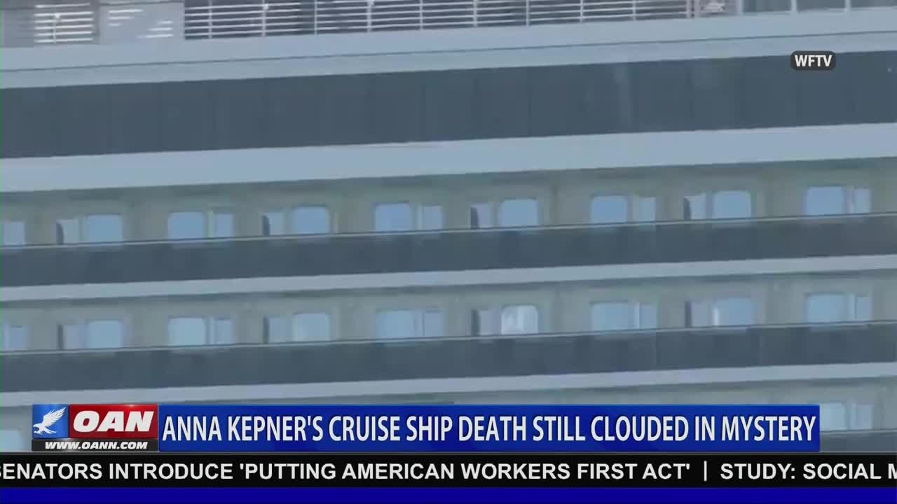A cruise ship's side fills the screen, with rows of windows reflecting the overcast sky. Below, the One America News Network logo and a headline about a cruise ship death are displayed.
