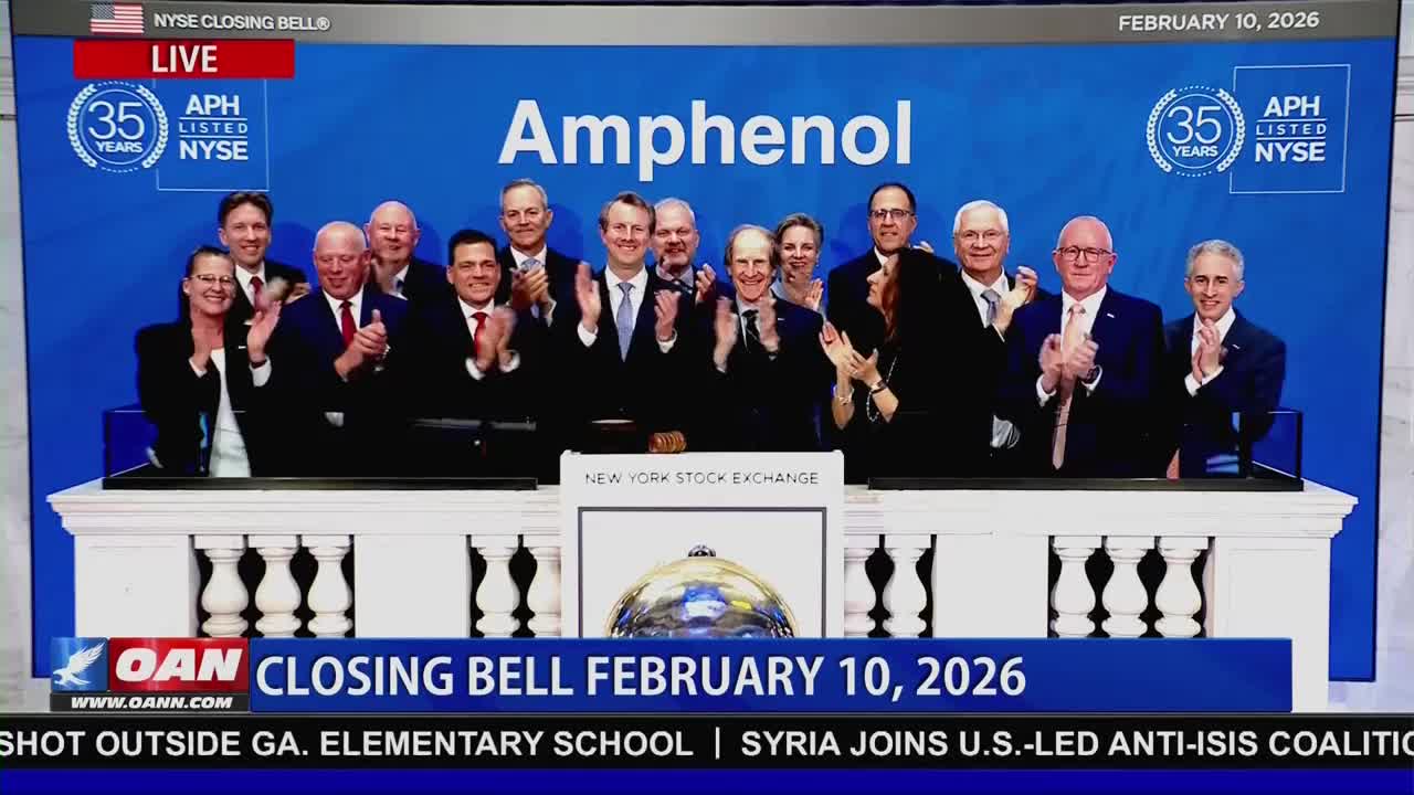 A group of people in suits are clapping on the New York Stock Exchange floor. The Amphenol logo is displayed prominently behind them.